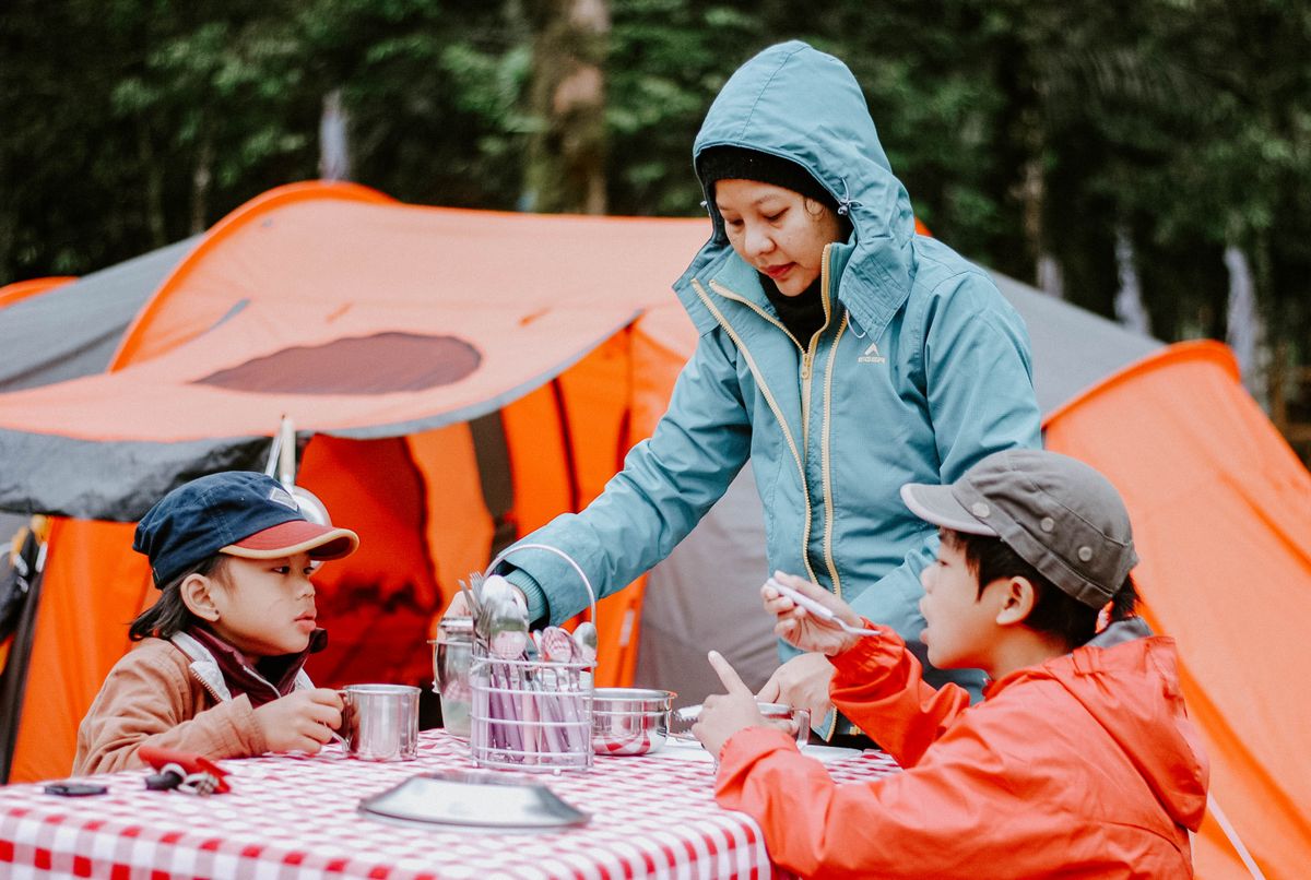 Foil packet dinner cooking over campfire coals