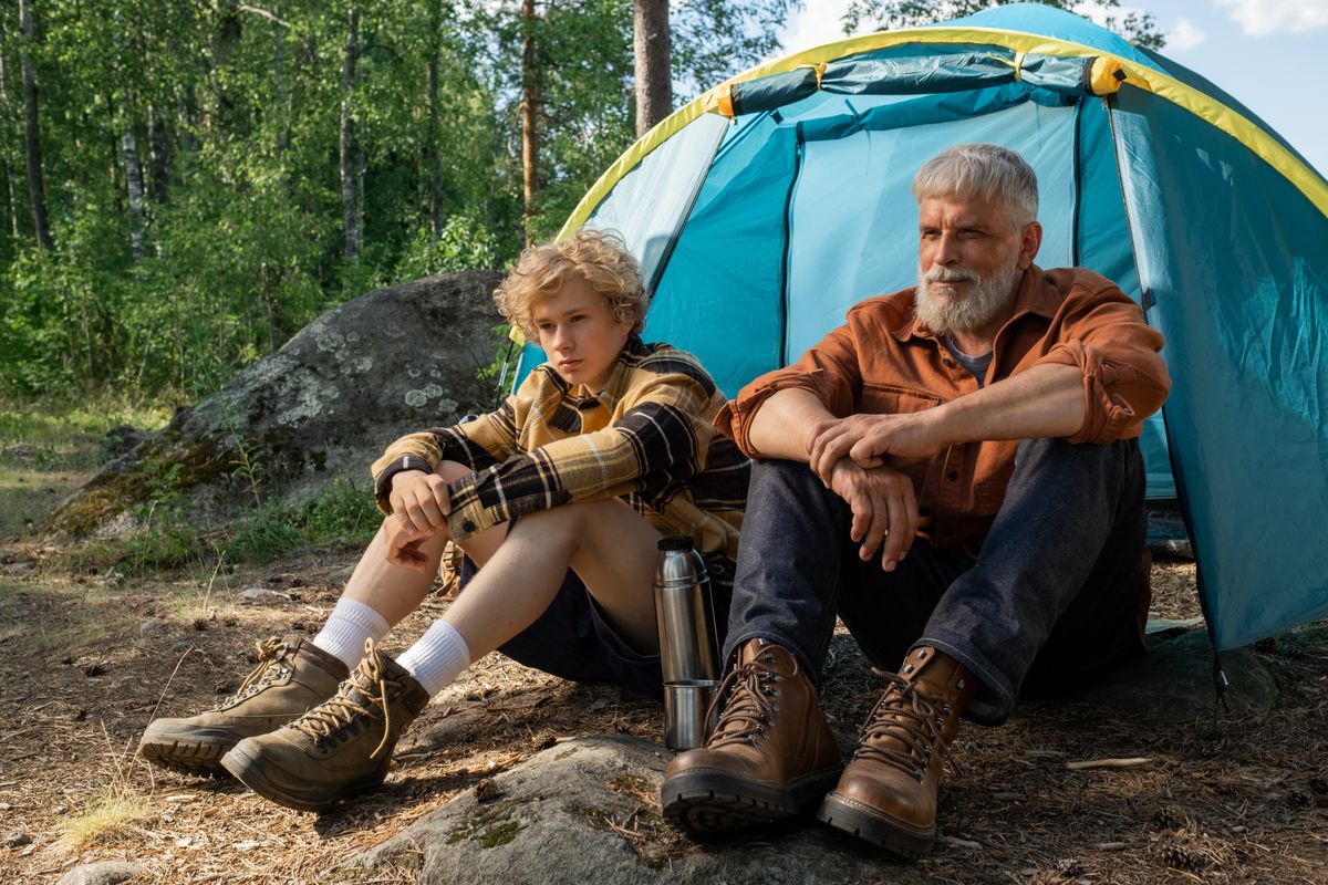 Family relaxing together around a campfire