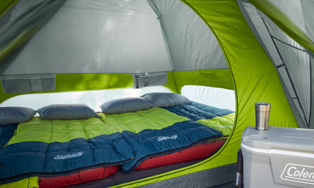 Coleman Skydome 6-Person tent set up at a campsite with family nearby