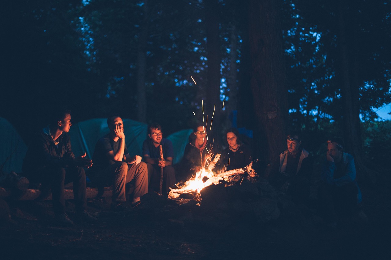 Kids telling stories around a campfire