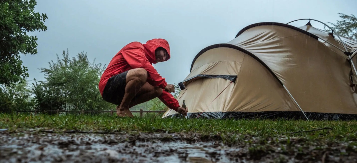A rainy day at a campsite with a tent under wet weather