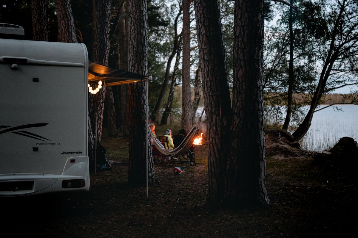 A glowing campfire at night with flames and embers