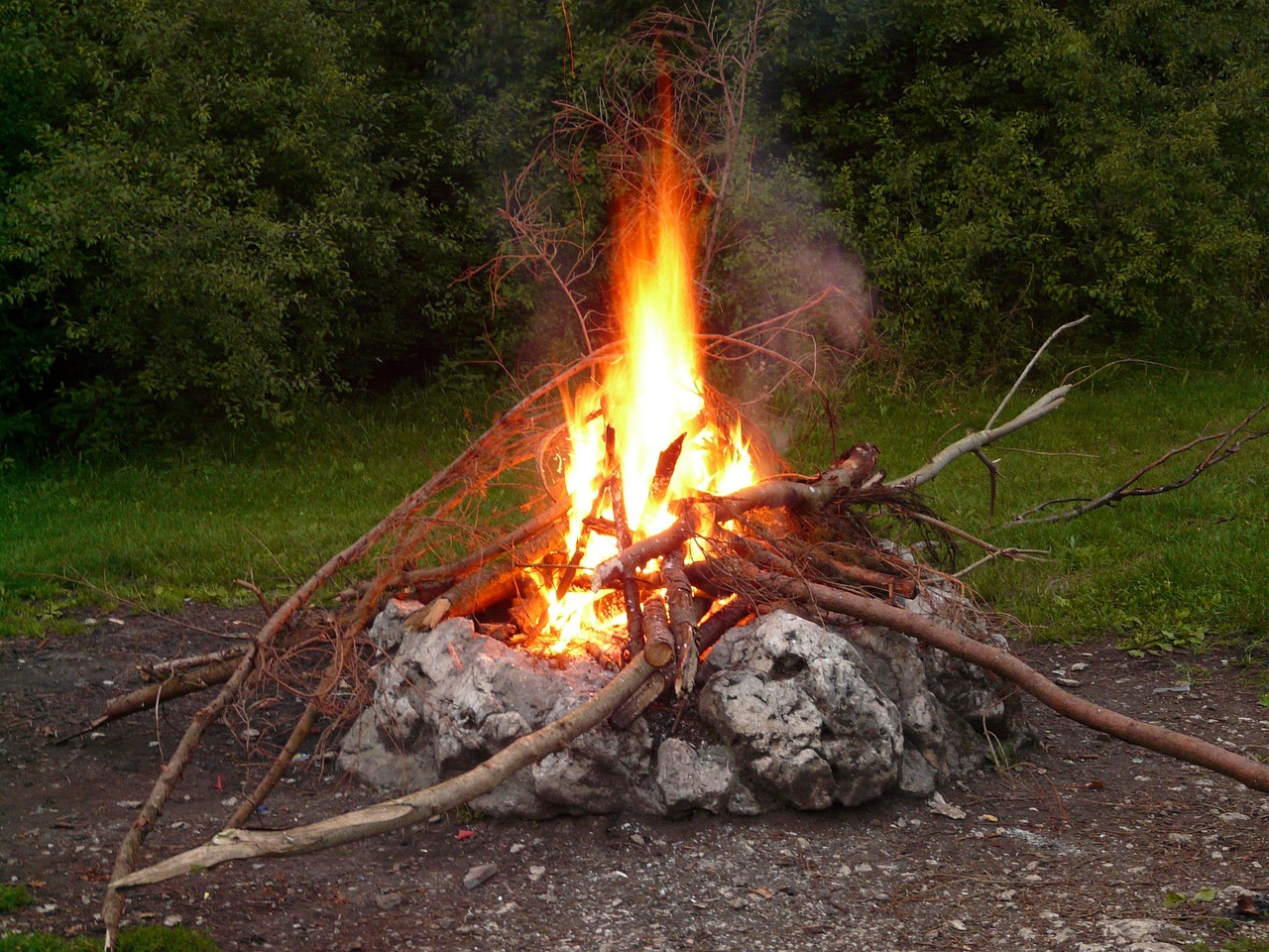Close-up of a small campfire with burning embers