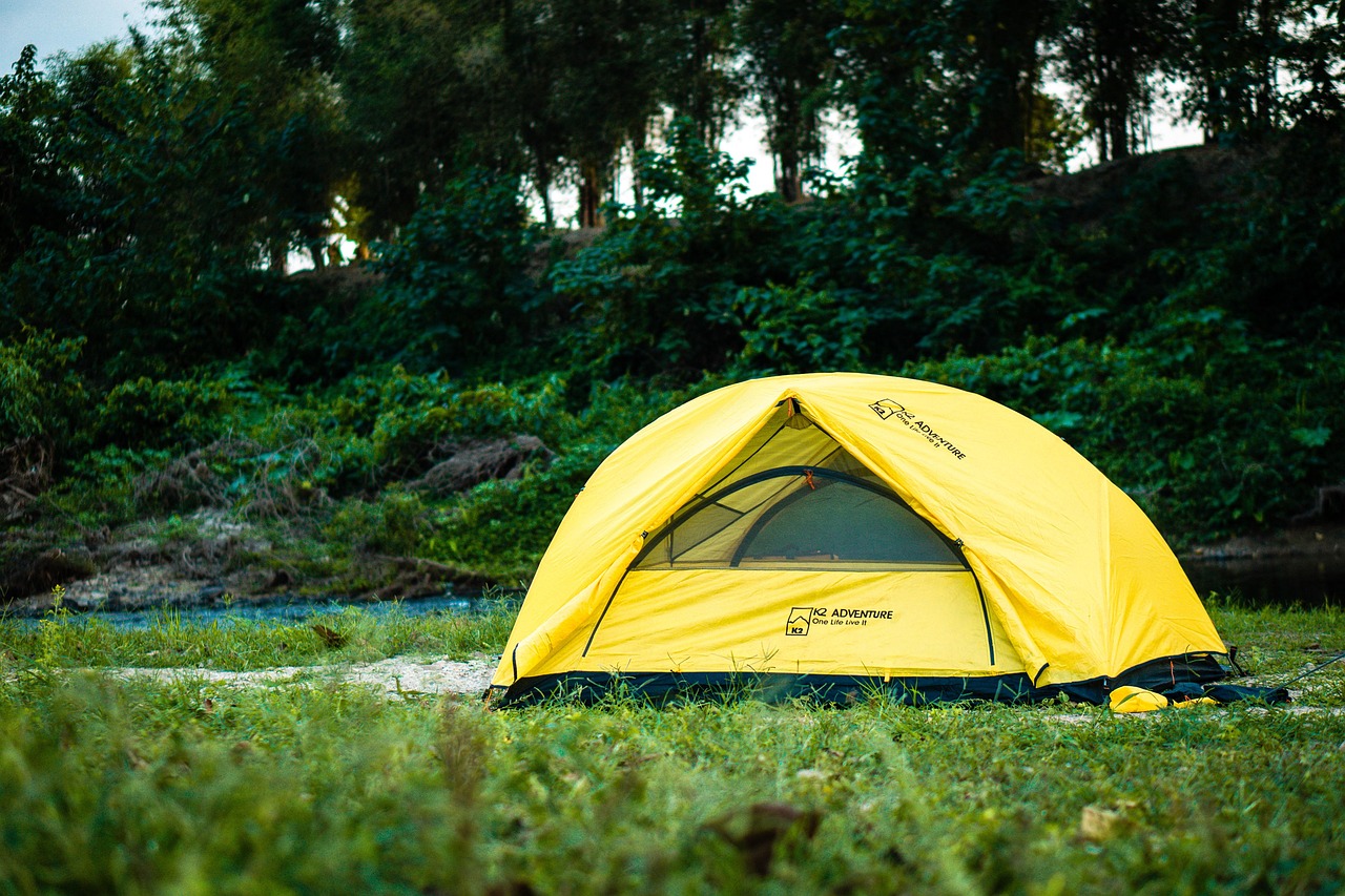 Family tent camping in a field at sunrise