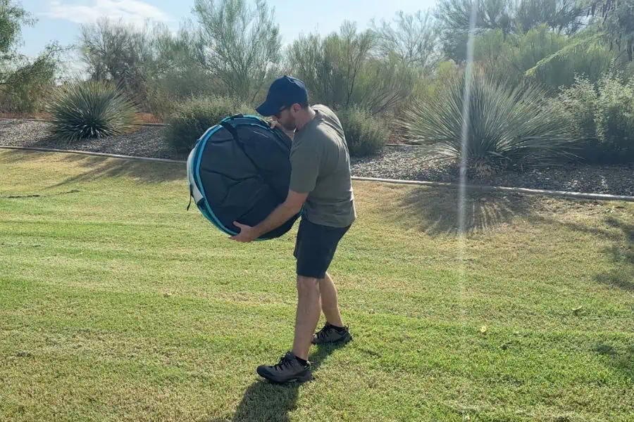 Family packing up camping gear into car