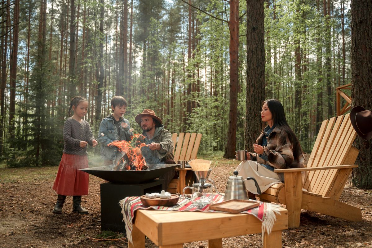 Family gathered around a warm campfire at dusk