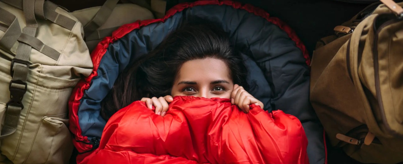 Cozy sleeping bag setup inside a tent at night