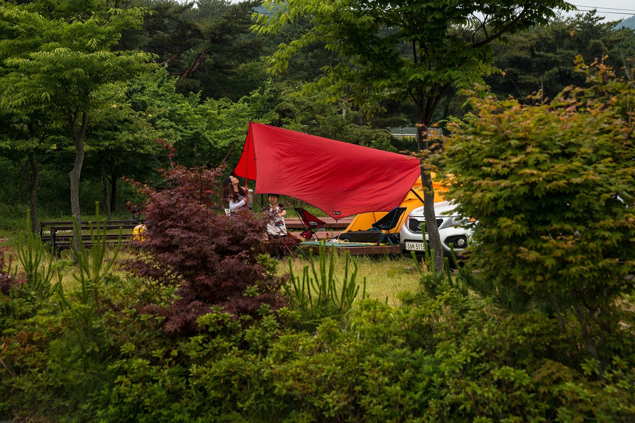 Family setting up a tent at a campground